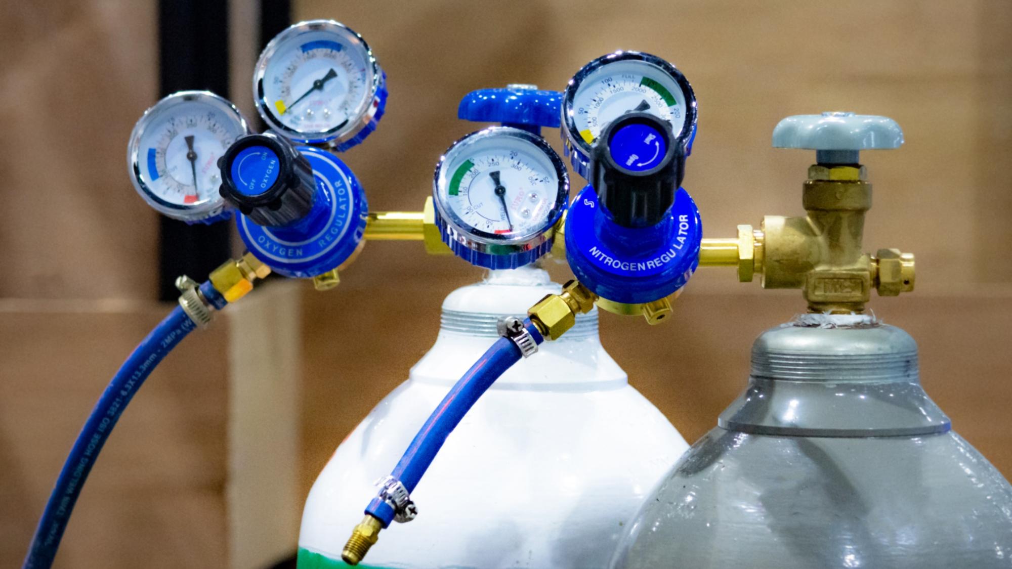Oxygen and nitrogen specialty gas regulators on labeled cylinders